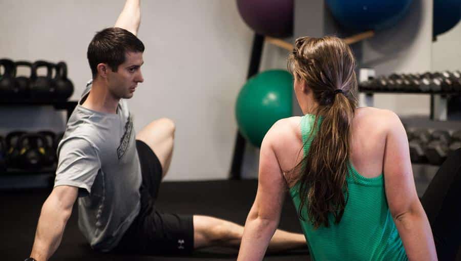 Paul Collins coaching a member through a floor exercise